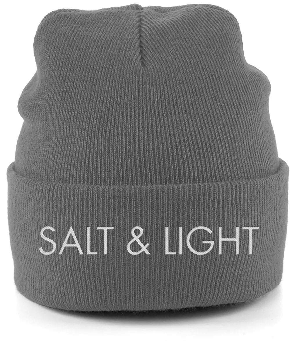 Close-up of a graphite grey cuffed beanie featuring high-quality white embroidery of the words 'SALT & LIGHT' in a modern, bold font