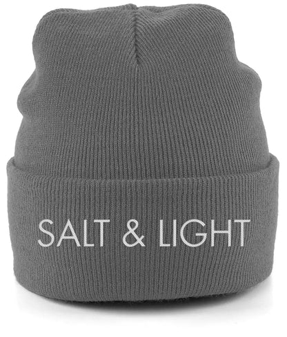Close-up of a graphite grey cuffed beanie featuring high-quality white embroidery of the words 'SALT & LIGHT' in a modern, bold font