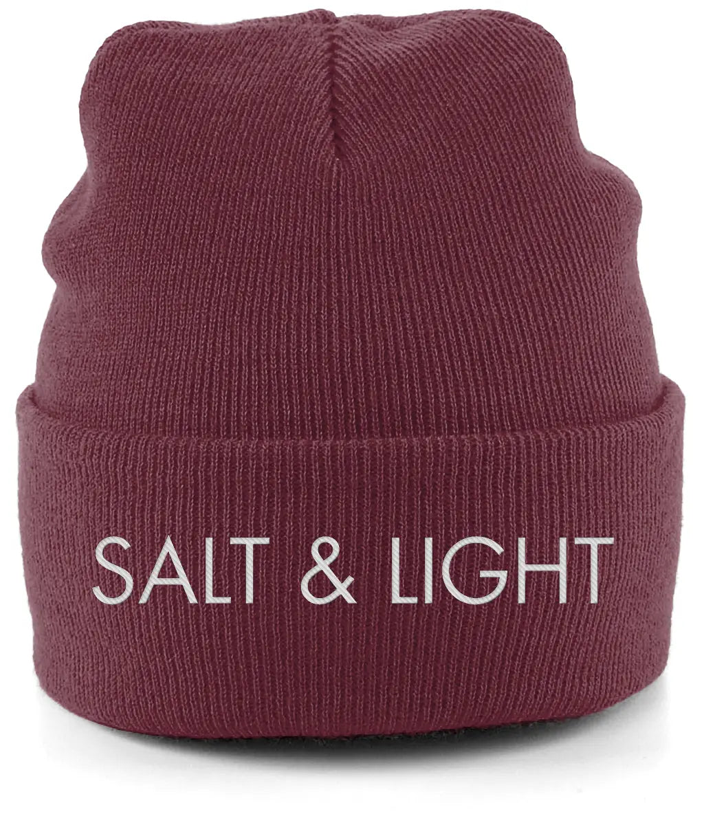 Close-up of a burgundy cuffed beanie featuring high-quality white embroidery of the words 'SALT & LIGHT' in a modern, bold font