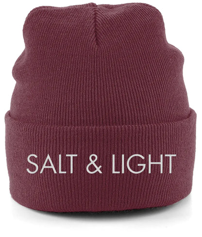 Close-up of a burgundy cuffed beanie featuring high-quality white embroidery of the words 'SALT & LIGHT' in a modern, bold font