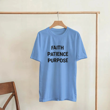 Light Blue t-shirt with black text FAITH PATIENCE PURPOSE on wooden hanger