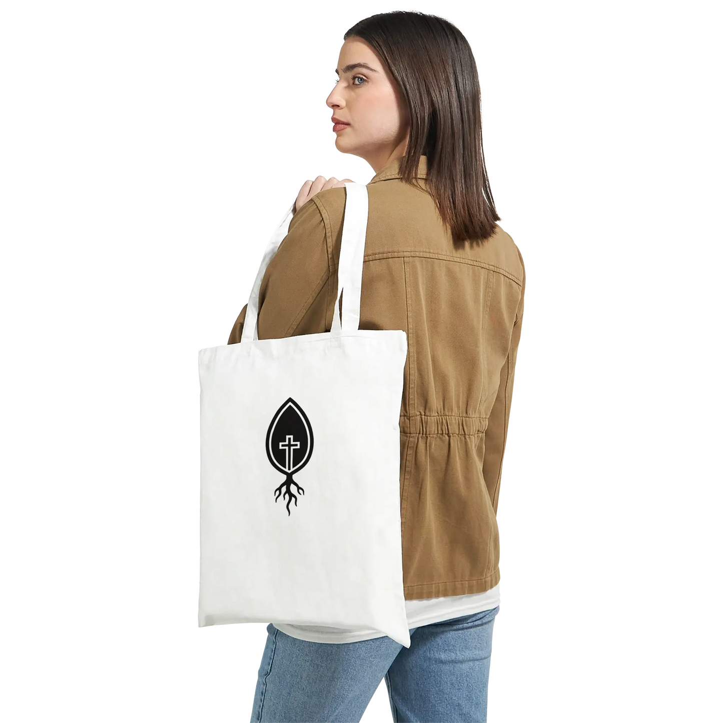 Woman wearing brown jacket holding Christian cross root logo canvas white tote bag