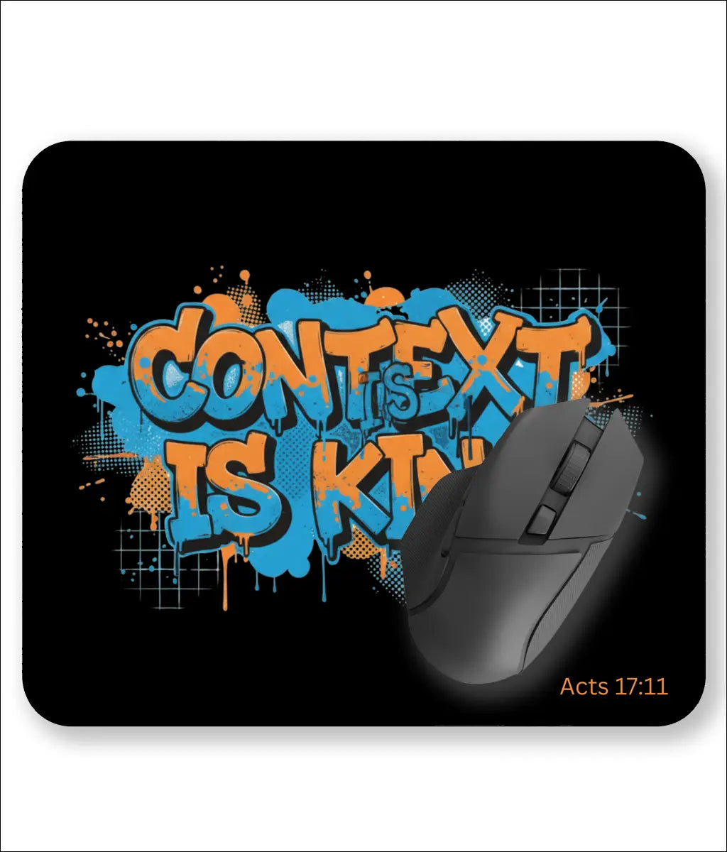 Premium black desk mat with bold minimalist white typography reading "Context Is King" and the scripture reference Acts 17:11, designed for a modern UK office.